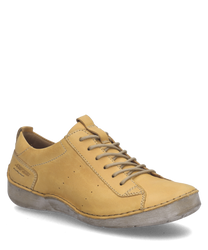 The shoe is a low-cut style with a lacing closure made from smooth yellow leather. It features a minimalist design and a light sole providing a casual yet stylish look ideal for everyday wear.