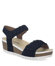 Sandalias negras de plataforma con cierre de velcro. La suela es de corcho con detalles blancos y la parte superior tiene un diseño trenzado.