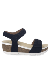 Sandalias negras de plataforma con cierre de velcro. La suela es de corcho con detalles blancos y la parte superior tiene un diseño trenzado.