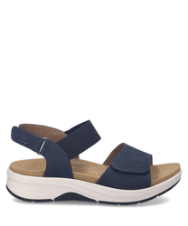 These sandals feature a navy blue leather-like material with Velcro closure and a cushioned tan insole offering comfort and support. The sole is white providing a stylish contrast.