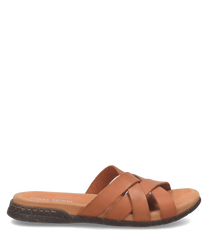 Brauner Slipper aus Leder ohne Verschluss. Der Schuh hat überkreuzte Riemen und eine flache Sohle für hohen Tragekomfort.