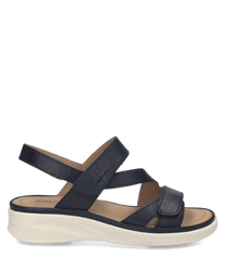 Sandales en cuir noir avec fermeture Velcro. Semelle blanche épaisse pour un confort optimal.