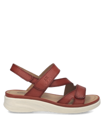 Sandalias de cuero marrón con cierre de velcro. Suela blanca de goma diseño cómodo y casual.