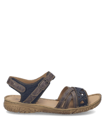 These sandals feature a brown leather material with a Velcro strap closure for easy adjustment. The sole is textured for grip and comfort making them ideal for casual wear.