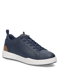 Zapato deportivo azul marino de cuero con cordones. Detalles marrones en el talón y suela blanca resistente.