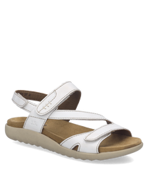 Sandalias blancas de cuero sintético con cierre de velcro. Suela beige y diseño cómodo ideal para el uso diario.