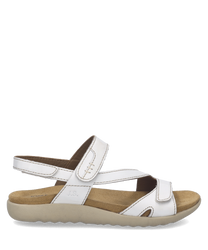 Sandalias blancas de cuero sintético con cierre de velcro. Suela beige y diseño cómodo ideal para el uso diario.