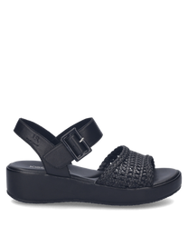 Black sandals featuring a woven strap design with a Velcro closure for easy adjustment. The sandals have a comfortable sole with a subtle platform providing both style and support.