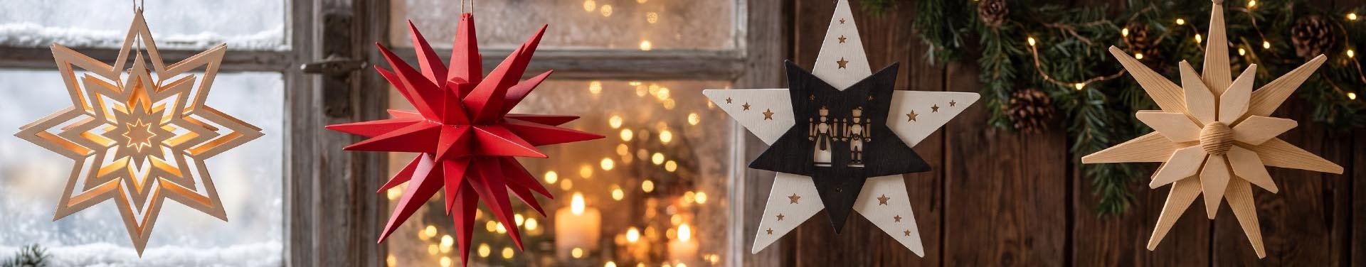 Weihnachtssterne aus Holz im Fenster, beleuchtet und in der Weihnachtsstube