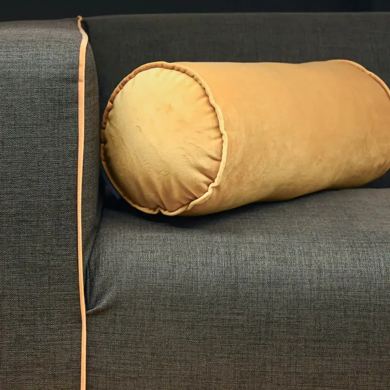 Sofa mit Mikrofaser-Polsterstoff und gelber Samtrolle