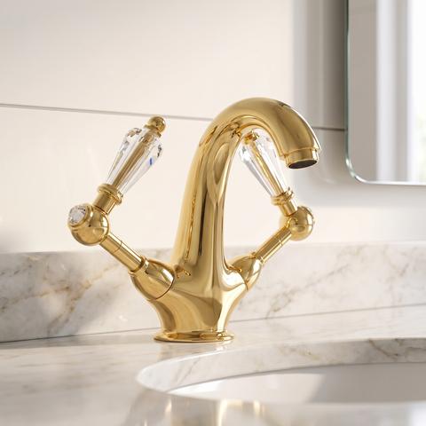 Rubinetto da lavabo dorato con maniglie in cristallo