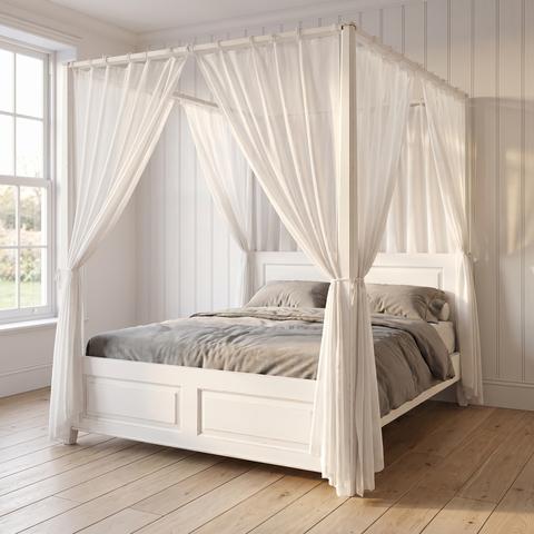 White country house style four poster bed with light curtains