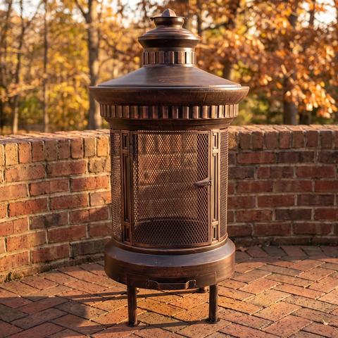 Copper and black metal terrace stove on a brick terrace