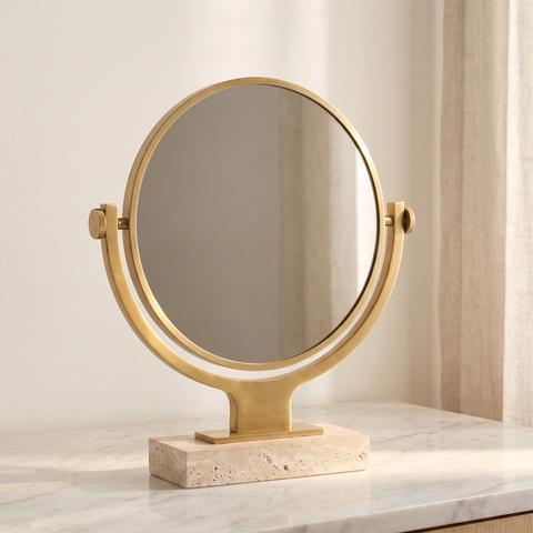 Luxury gold vanity mirror on a travertine base